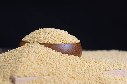 Fresh raw porridge couscous from wheat or millet, cooking dishes from traditional cereals of crushed yellow couscous