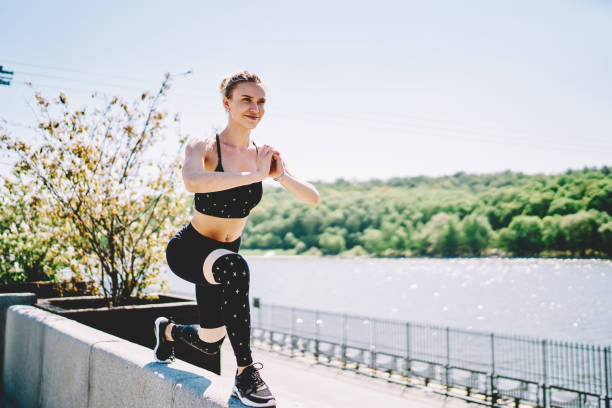 istock Cheerful woman enjoying crouching and clasping hands outside 1432438240