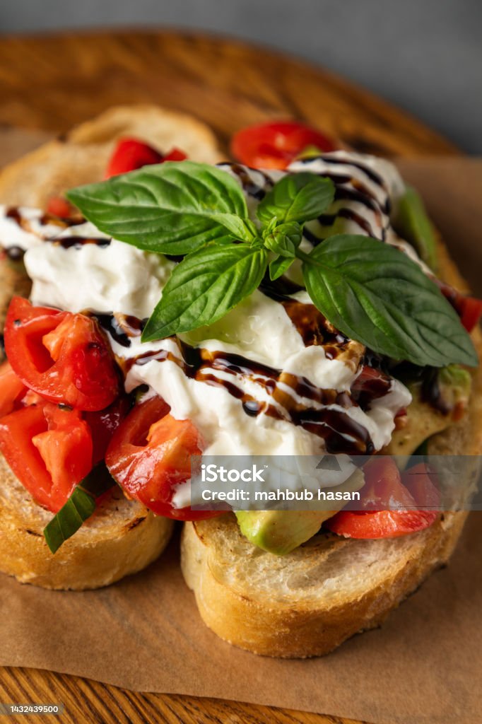 Toasts of dark bread with avocado slices, healthy toasts with avocado and Caviar Roe background Farm-To-Table Stock Photo