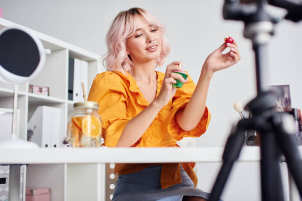 istock Beautiful woman speaking on camera about perfume 1432441063