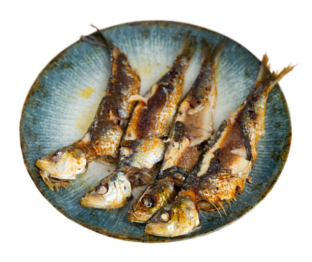 Just cooked fried sardines served on table