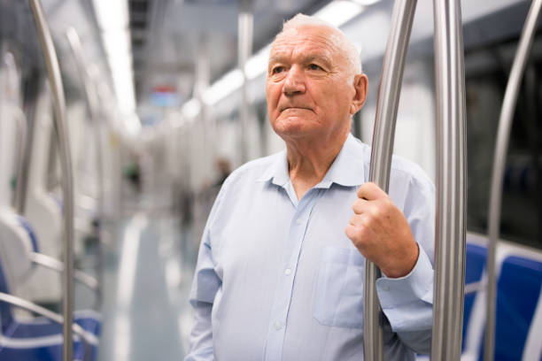 istock Old man standing in subway car 1432442954