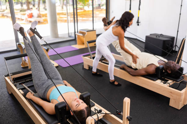 istock Active young Woman doing pilates exercises lying on pilates workout machines 1432444617