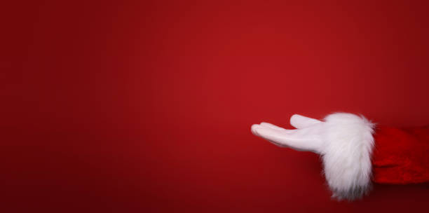 istock Santa Claus hand presenting your text, product, advertisement on a red background.Mockup. Copy space. Banner 1432445217