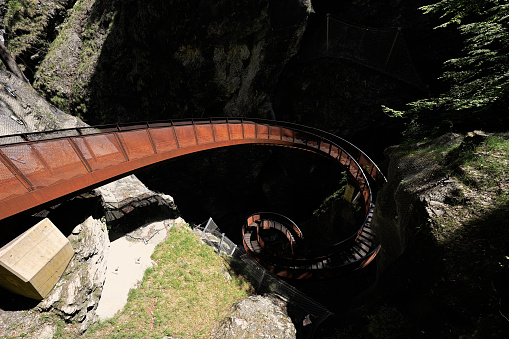 Metal spiral staircase in Liechtensteinklamm or Liechtenstein Gorge, particularly narrow gorge with walls, located in the Austrian Alps, near Salzburg, Austria.