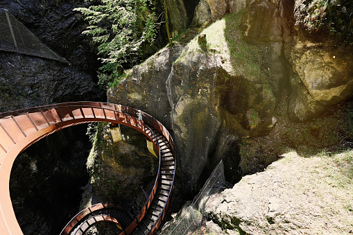 Mother with children walking in metal stairs in Liechtensteinklamm or Liechtenstein Gorge, Austria.