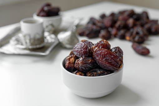 Plate with dried sweet prunes with ripe plums in wooden box.