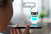 Artificial intelligence,ai chat bot concept. hands holding mobile phone on blurred abstract background. chatbot answering questions online