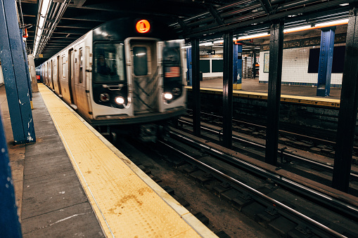 A modern New York subway train arriving to a station in Manhattan.