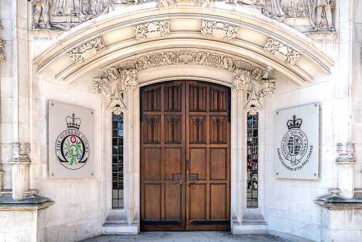 London, UK - 26 March 2022: The entrance to The Supreme Court, Parliament Square, London. Home to the Judicial Committee of the Privy Council.