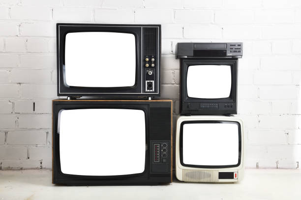 istock Four old vintage white screen televisions and a VCR stand against a white brick background. 1432460503