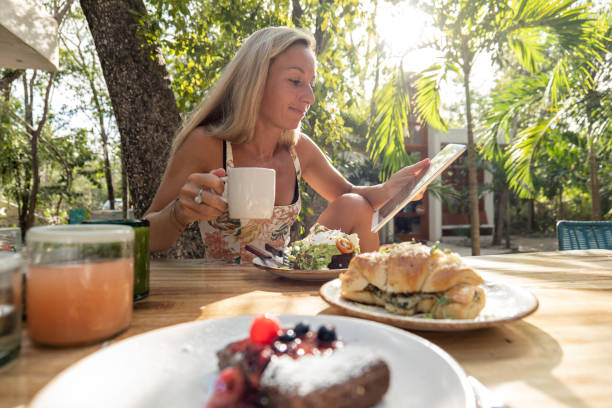istock Young woman using a digital tablet, outdoor cafe 1432460542