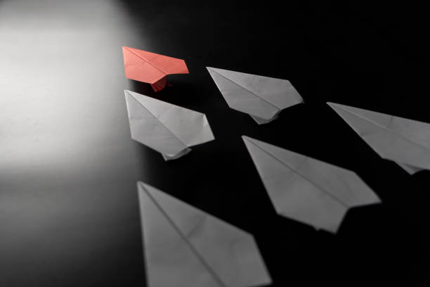 istock Different thinking concept. Red paper plane leaving the group. Red paper plane leading white ones 1432460680