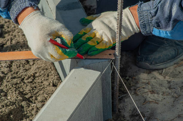 istock A worker measures a concrete block with a ruler, close-up. 1432462556