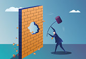 istock Business man smashes the partition wall with a sledgehammer 1432462590