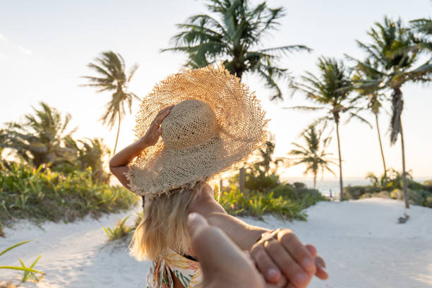 istock POV couple walking towards tropical beach at sunset 1432463001