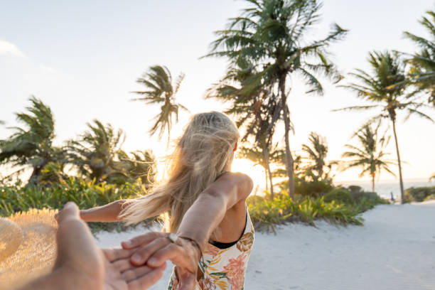 istock POV couple walking towards tropical beach at sunset 1432463094