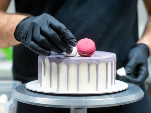 istock chef decorating romantic lilac white frosted dripping cake macaron meringue top 1432463971