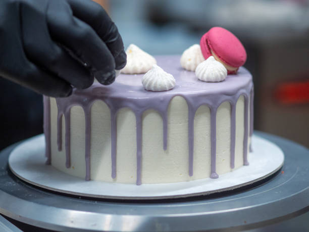 istock chef decorating romantic lilac white frosted dripping cake macaron meringue top 1432463975