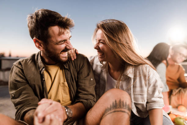 istock Cheerful couple having fun on a rooftop. 1432464378