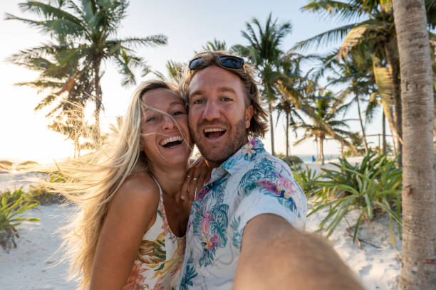 istock Couple takes selfie on tropical beach at sunset 1432464406