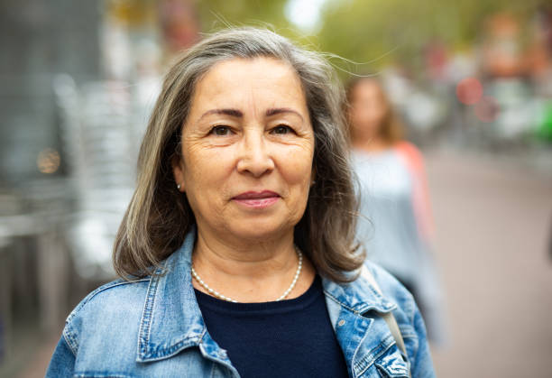 istock Smiling modern aged woman enjoying walk around city 1432464701