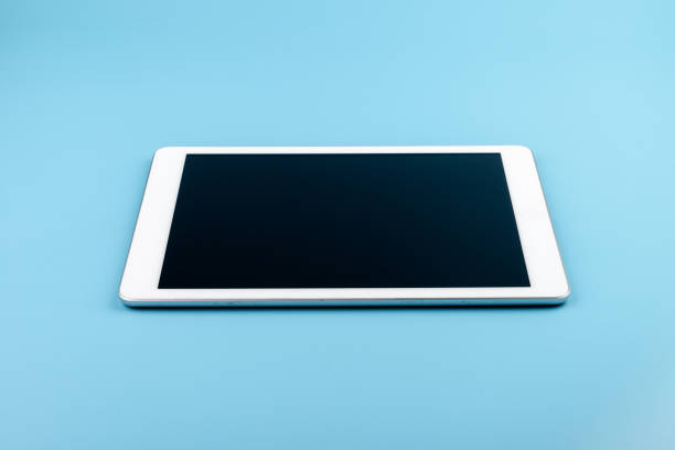 Modern digital tablet isolated on blue background with copy space