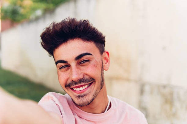 istock Cheerful young man looking at camera on street 1432465984
