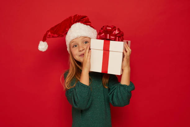 istock Smiling funny child (kid, girl)  holding Christmas gift box 1432466449
