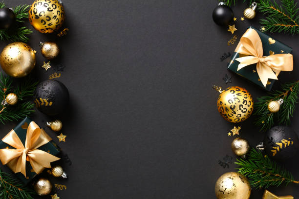 istock Christmas frame. Black Xmas background with gold baubles, gift boxes, fir branches. Flat lay, top view, copy space. 1432467160