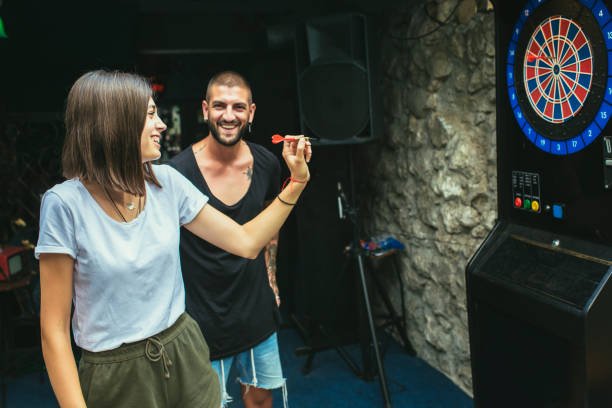 istock Young attractive couple playing darts 1432470376