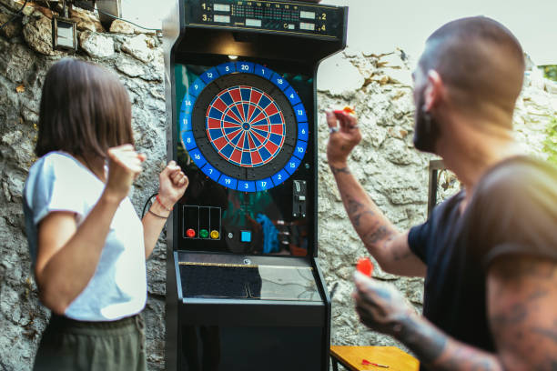 istock Young attractive couple playing darts 1432470379