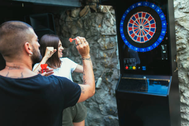 istock Young attractive couple playing darts 1432470387
