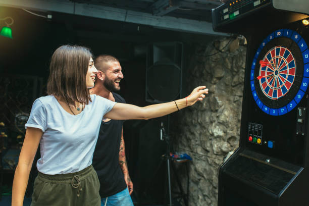 istock Young attractive couple playing darts 1432470391