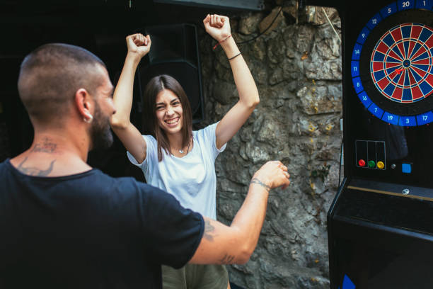 istock Young attractive couple playing darts 1432470397