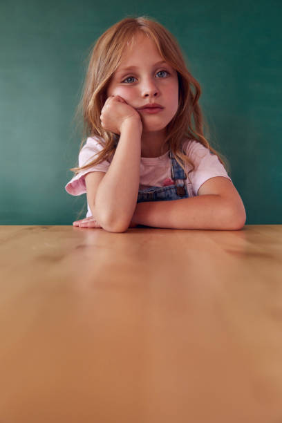 istock Funny kid against green chalkboard 1432471585