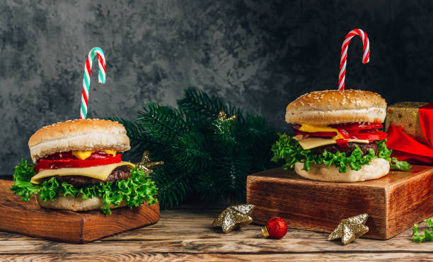 istock Christmas burger concept, with candy cane and christmas gift box. Dark background, Selective focus 1432471893