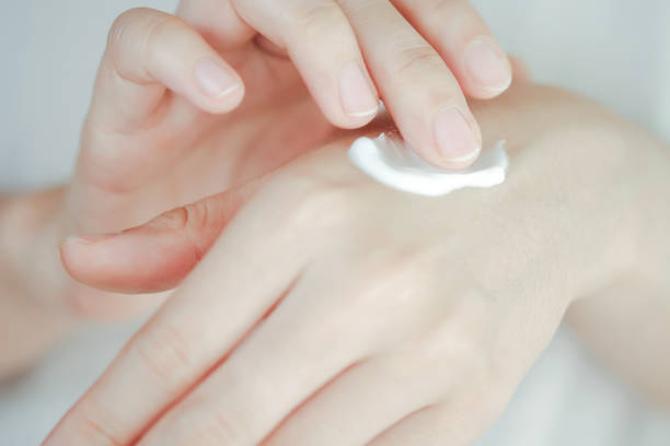 istock Woman's hands applying cream. Skin care concept. 1432474993