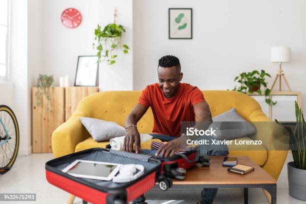 Young Man Packing Travel Bag For Summer Vacation Stock Photo - Download Image Now - Suitcase, Packing, Vacations
