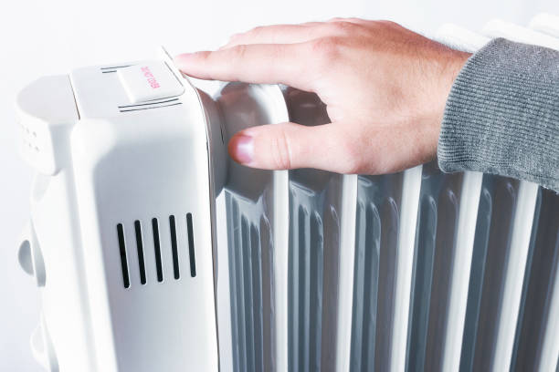 istock male hand and heater concept low temperature indoors 1432475793
