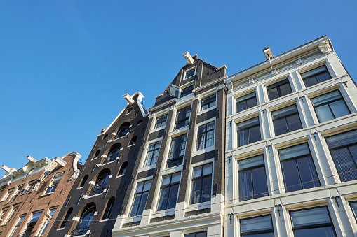 Low angle view of canal houses in Amsterdam, The Netherlands