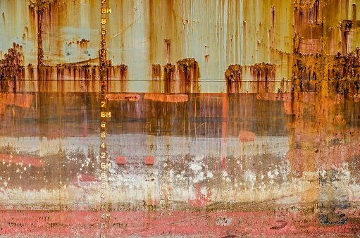 Almost abstract section of an old ship's hull with all kinds of dirt, rust, scratches and other signs of ageing