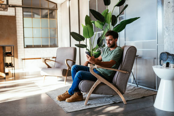 istock Cheerful Caucasian man working from home and using smart phone for communication 1432483116