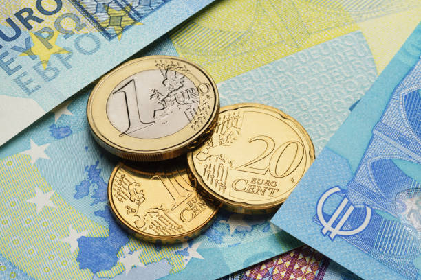istock Euro coins on the blue paper bills. 1432484213