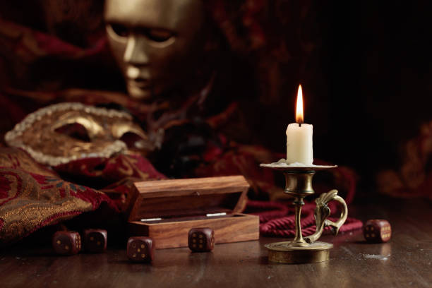 istock Burning candle, dice, and carnival masks. 1432484726