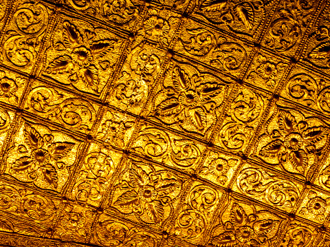 Beautiful Burmese art pattern motifs decorative design on the golden walls of the temple's room