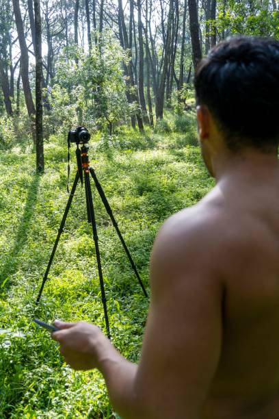 istock Young Hispanic athletic man video blogging in a forest before or after a workout 1432485337