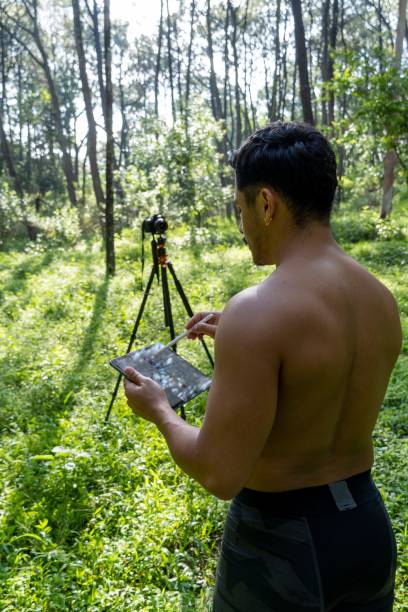 istock Young Hispanic athletic man video blogging in a forest before or after a workout 1432485339
