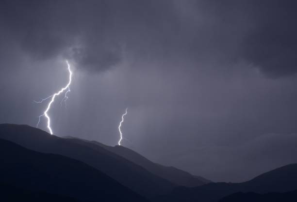 istock Dark, stormy night in the mountains with violent lightning striking the peaks under a cloudy sky 1432486636