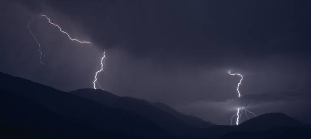 istock Scenic view of lightning striking at night on hills 1432487007